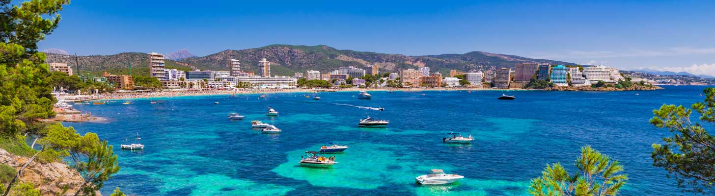 Boats in the blue sea of Magaluf bay in Majorca
