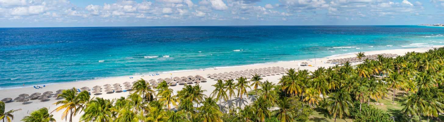 Sun loungers on the white sands of a beach in Varadero, Cuba