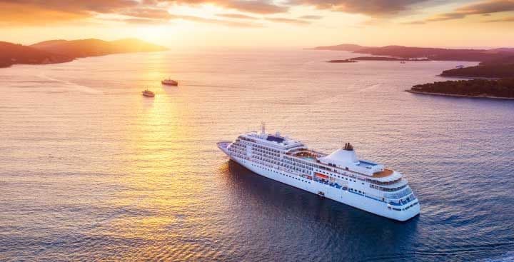 Cruise ship sailing into sunset