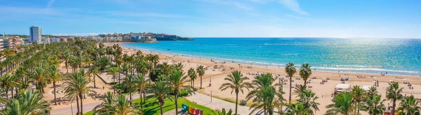 Palm trees lining the golden sandy beaches of Salou in Costa Dorada