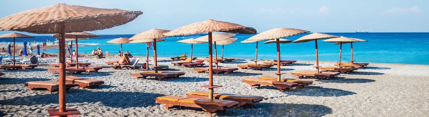 Sun loungers & umbrellas on a beach in Rhodes