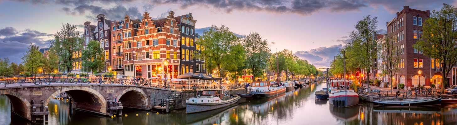 Boats on the canal in Amsterdam at dusk