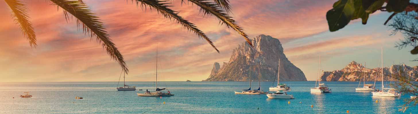 Boats in the water at sunset in Ibiza