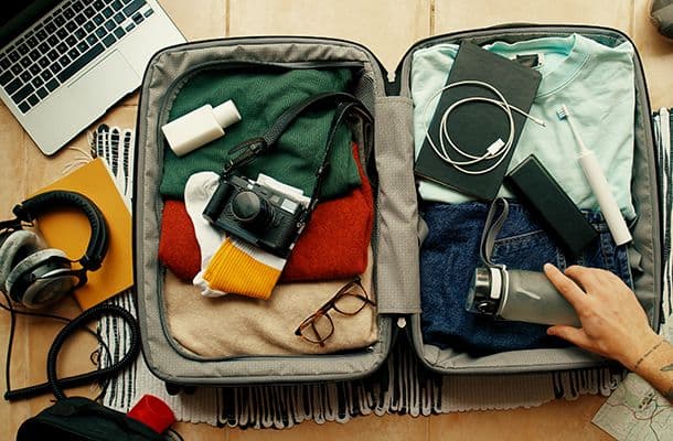 Person packing a suitcase
