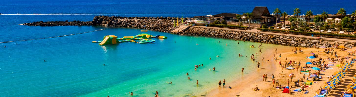People on the beach at Playa de Amadores in Gran Canaria