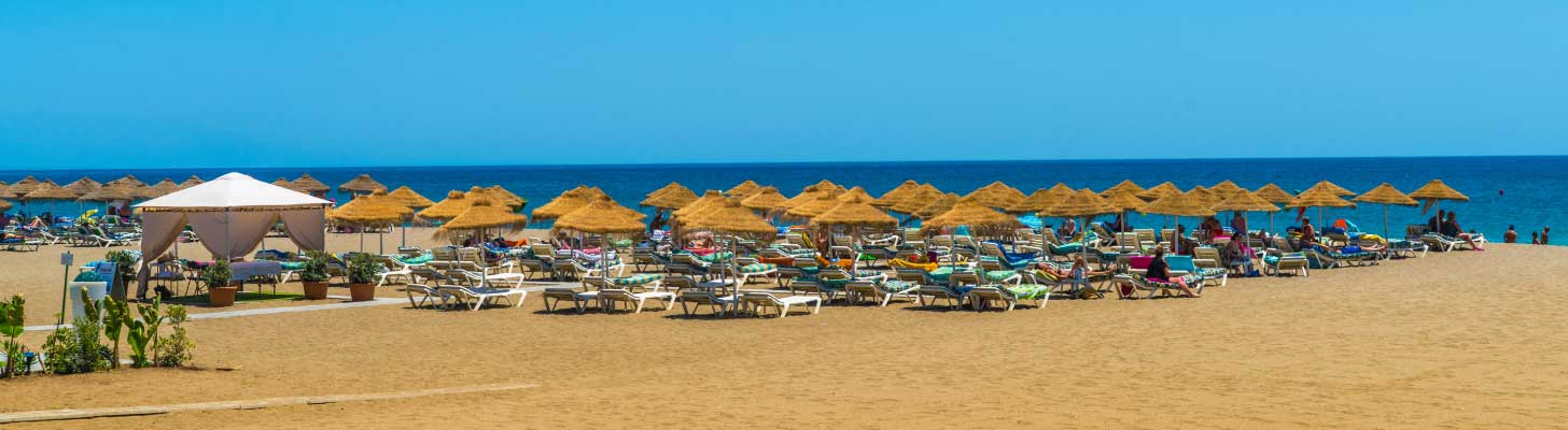 Sunbeds & umbrellas on the sands of a beach in Benalmadena, Costa del Sol